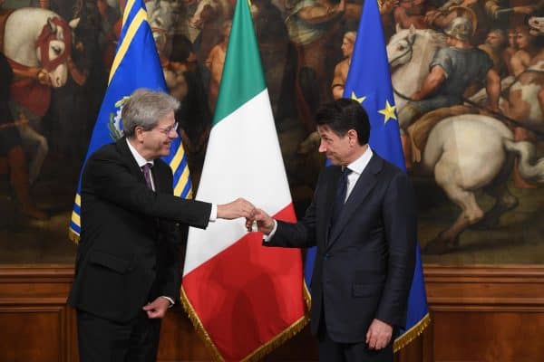 Newly appointed Italian Prime Minister Giuseppe Conte (right) receives from the outgoing Prime Minister Paolo Gentiloni (left) the small silver bell to open the First Council of Minister at Chigi Palace in Rome, 1 Jun 2018. ANSA/CLAUDIO PERI
