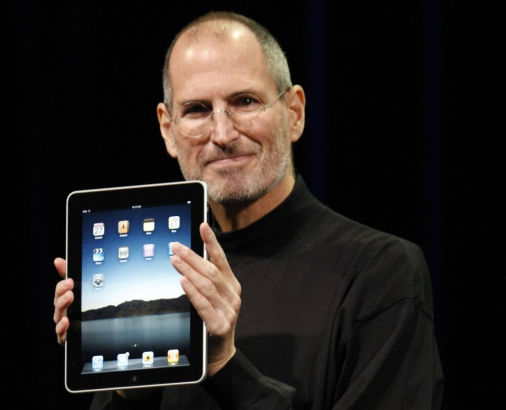 Apple CEO Steve Jobs shows off the new iPad during an event in San Francisco, Wednesday, Jan. 27, 2010. (AP Photo/Paul Sakuma)