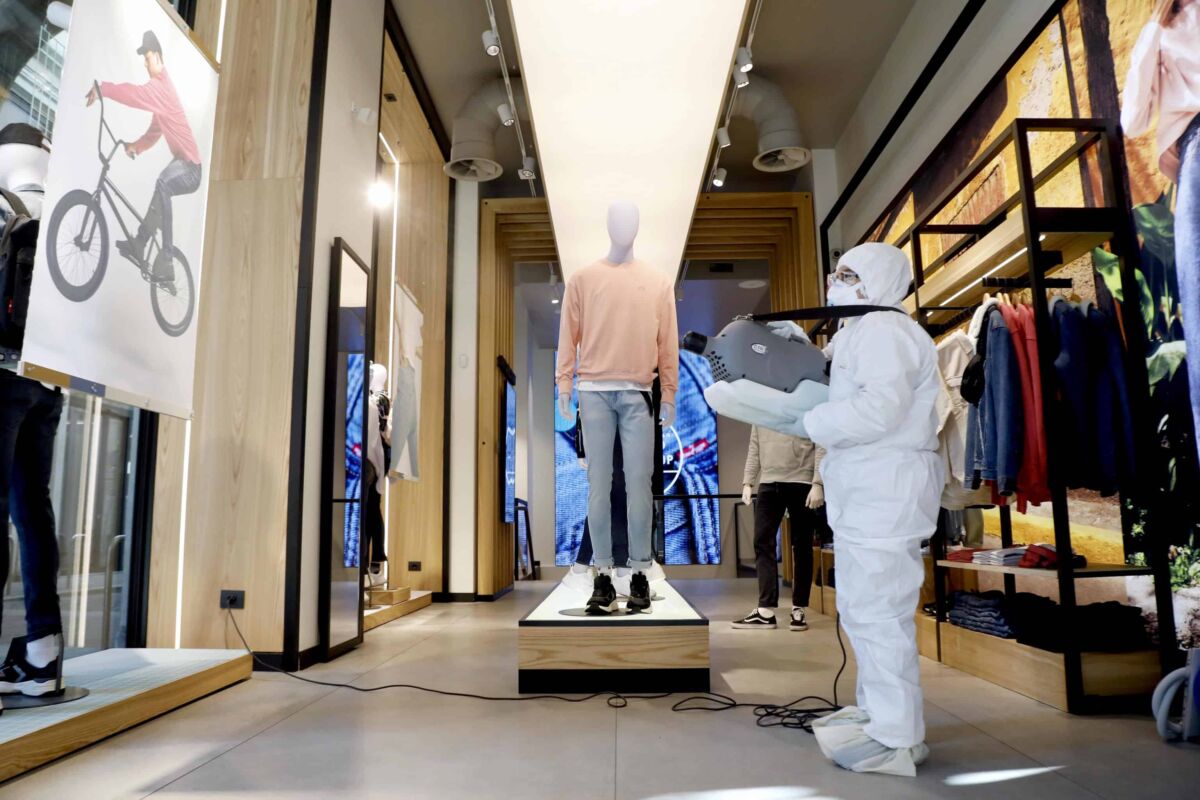 A private company employee sanitizes a clothing store in the center of Milan ahead of phase 2 of the gradual reopening of commercial activities during the Coronavirus emergency in Milan, April 22, 2020. ANSA/Mourad Balti Touati