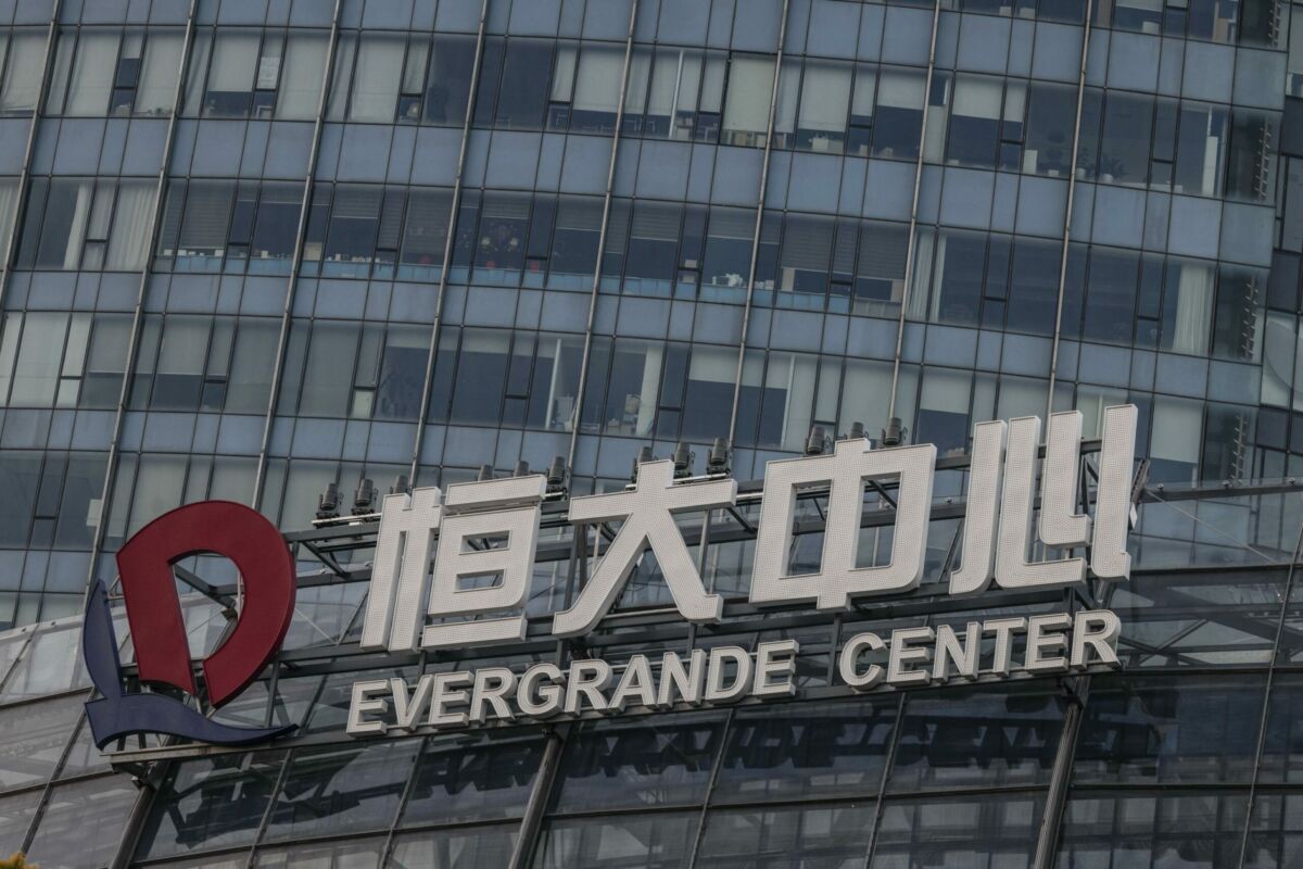 epa09479217 The Evergrande Center logo hangs outside a building in Shanghai, China, 21 September 2021. Evergrande Group is Chinas real estate conglomerate and the worlds most indebted property developer. Stock markets in Asia, the USA, and Europe were hit by a major sell-off on 20 September since the companys shares closed 10 percent lower in Hong Kong. The Evergrande Group announced its concern in a stock filing this month that the group might not be able to meet its financial obligations.  EPA/ALEX PLAVEVSKI