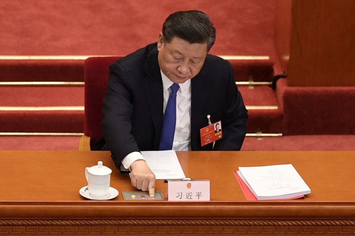 (FILES) This file photo taken on May 28, 2020 shows China's President Xi Jinping voting on a proposal to draft a security law on Hong Kong during the closing session of the National People's Congress at the Great Hall of the People in Beijing. - China passed a sweeping national security law for Hong Kong on June 30, 2020, a historic move that critics and many western governments fear will smother the finance hub's freedoms and hollow out its autonomy. (Photo by NICOLAS ASFOURI / AFP)