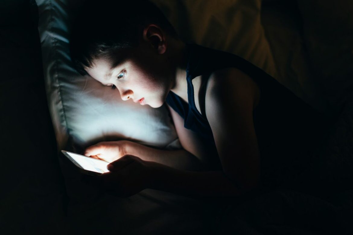 7,Years,Old,Child,Boy,Using,Smartphone,At,Night,In