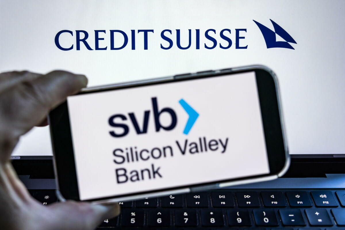 epa10522386 A photo illustration shows the Silicon Valley Bank (SVB) logo on a mobile device in front of a laptop with the Credit Suisse logo in Washington, DC, USA, 14 March 2023. Several days after SVB's collapse on 10 March, the Switzerland-based bank Credit Suisse reported that it found 'material weakness' in its financial reporting for the last two years.  EPA/JIM LO SCALZO