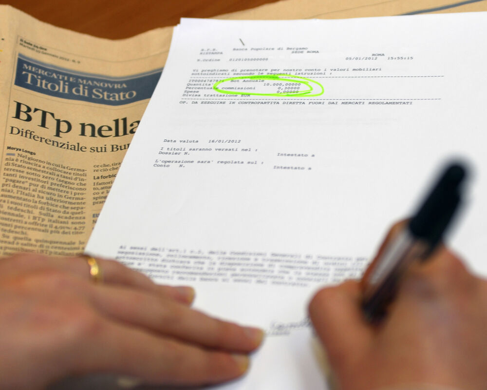 Un momento dell'atto della firma della richiesta di acquisto di Buoni Ordinari del Tesoro (BOT) presso una banca, Roma, 10 gennaio 2012. ANSA / ALESSIO TARALLETTO