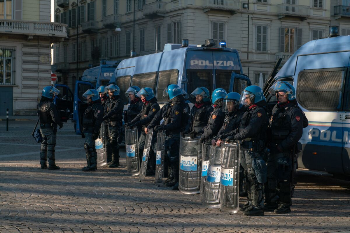 Italian,Police,Officers,,In,Riot,Gear,,Lined,Up,Against,A