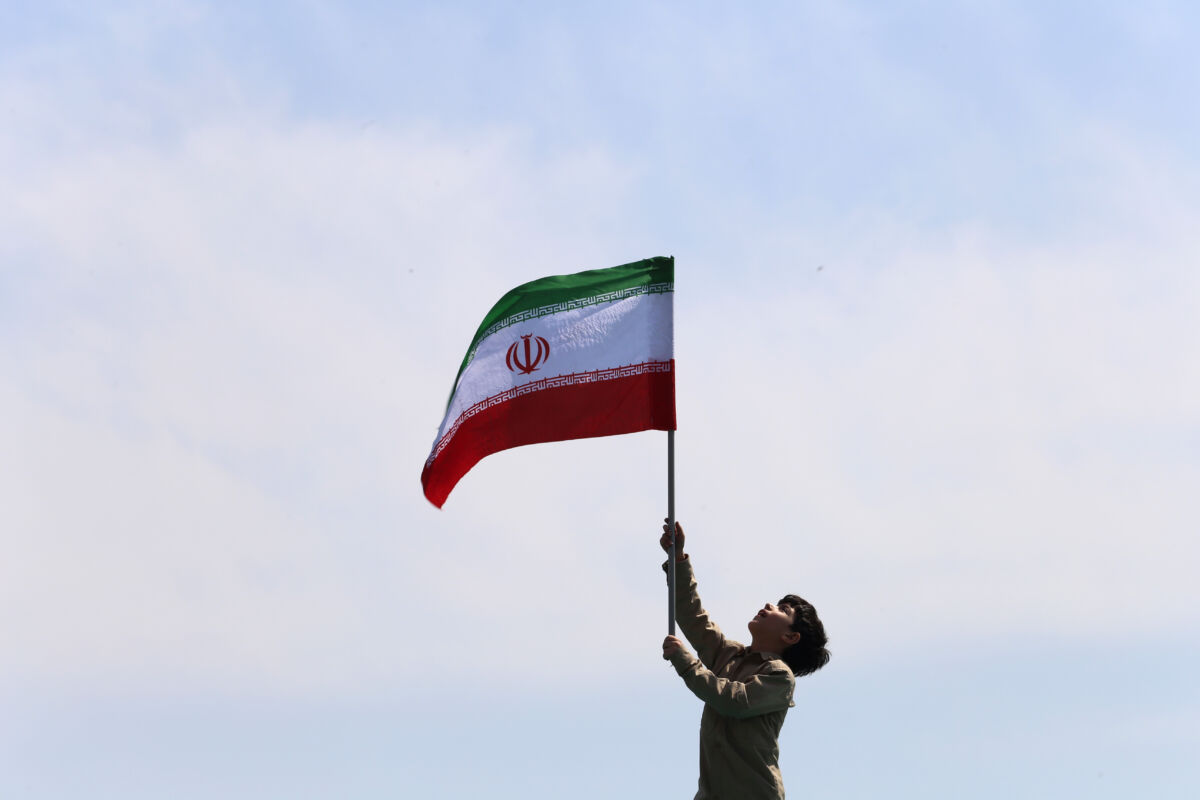 April 19, 2024, Tehran, Iran: An Iranian boy waves a flag of Iran during an anti-Israel rally in Tehran. Air defense systems over the central city of Isfahan destroyed three aerial objects early on April 19. The explosions come after a drone and missile attack carried by Iran's Islamic Revolutionary Guards Corps (IRGC) towards Israel on April 13, following an airstrike on the Iranian embassy in Syria, which Iran claimed was conducted by Israel. World leaders appealed for calm on April 19 after reported Israeli retaliation against Iran added to months of tense spillover from the war in Gaza, with Iranian state media reporting explosions in the central province of Isfahan. (Credit Image: © Rouzbeh Fouladi/ZUMA Press Wire)