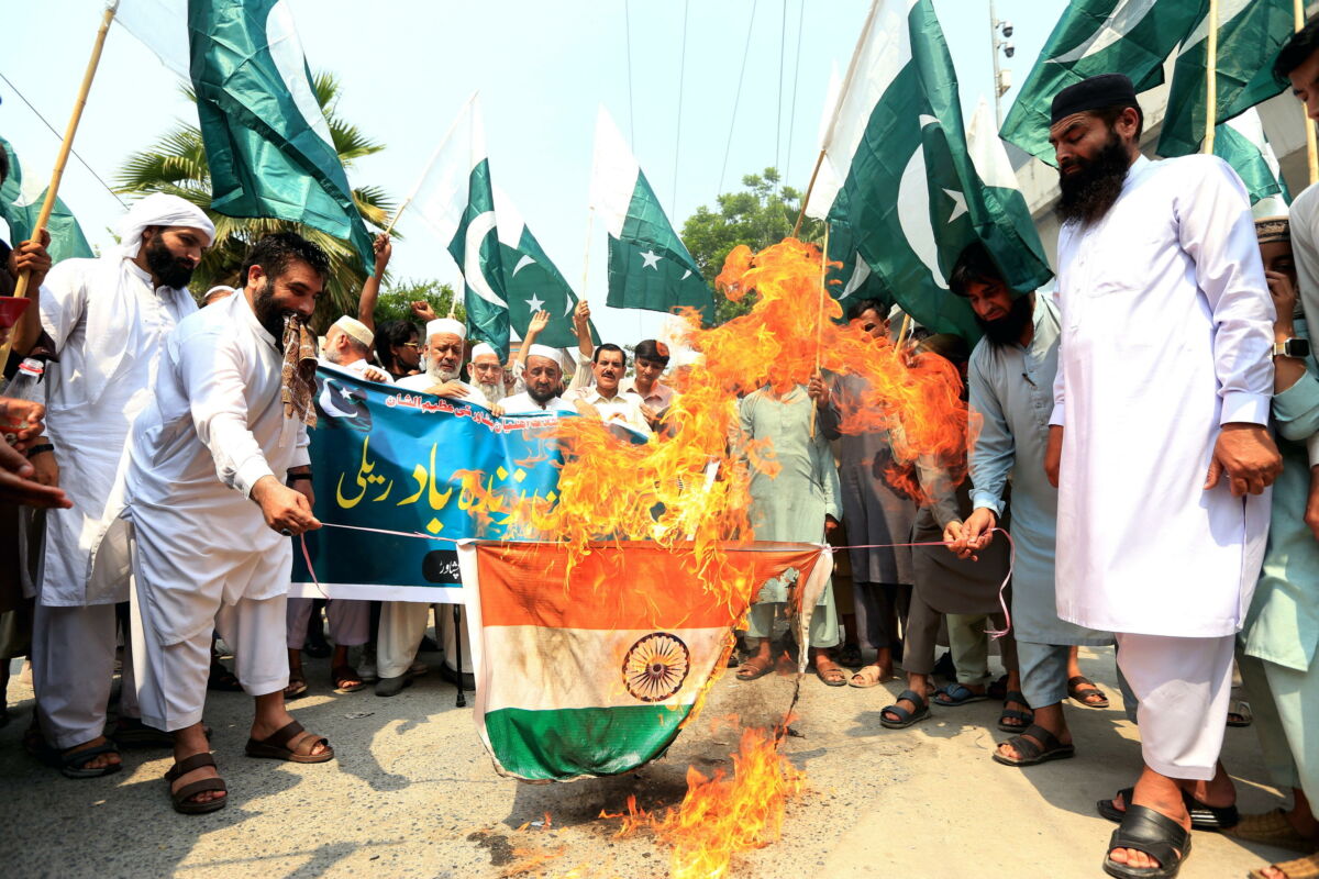 epaselect epa12080159 Supporters of Islamic political party Pakistan Markazi Muslim League (PMML) burn an Indian flag during a protest after India launched missile strikes in Pakistan, in Peshawar, Pakistan, 07 May 2025. India said it conducted military strikes on nine sites in Pakistan in retaliation for a deadly militant attack on tourists in India-administered Kashmir.  EPA/ARSHAD ARBAB