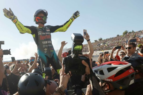 epa09582065 Italian Moto GP rider Valentino Rossi interacts with supporters at his last professional race at the Motorcycling World Championship at Cheste racetrack in Valencia province, eastern Spain, 14 November 2021.  EPA/Kai Foersterling