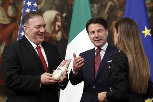 U.S. Secretary of State, Mike Pompeo, left, holds a package of parmesan cheese he was given by a journalist as Italian Premier Giuseppe Conte stands beside him, following their meeting at Chigi Palace premier's office in Rome, Tuesday, Oct. 1, 2019. 2019. U.S. Secretary of State Mike Pompeo is in Italy at the start of a four-nation tour of Europe as the push to impeach President Donald Trump gains steam at home. (AP Photo/Andrew Medichini)