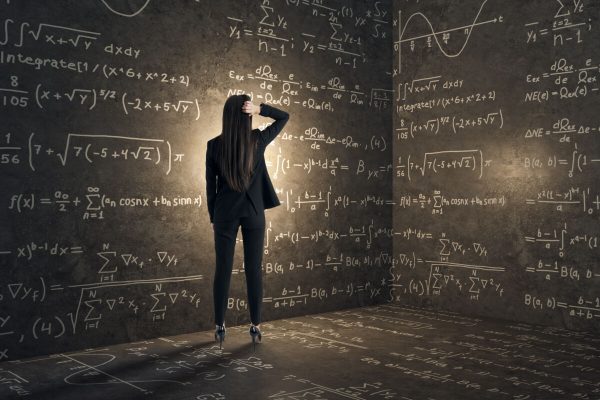 Back,View,Of,Young,Businesswoman,In,Concrete,Corner,With,Mathematical