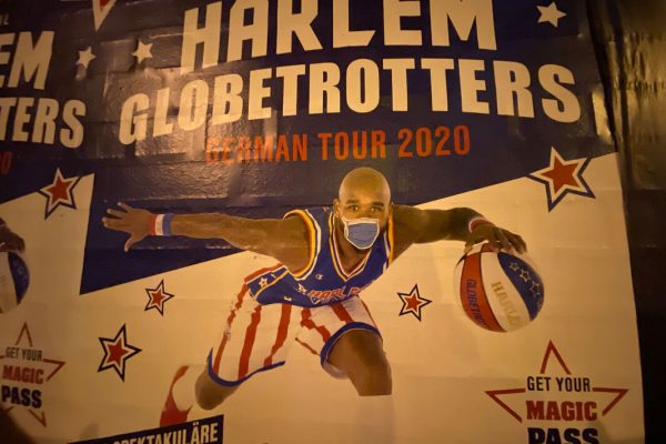 FILED - 06 April 2020, Berlin: On an advertising poster for the Harlem Globetrotters' guest appearance in Berlin, unknown persons stuck a mouthguard on a player's face. Photo: Paul Zinken/dpa-Zentralbild/dpa