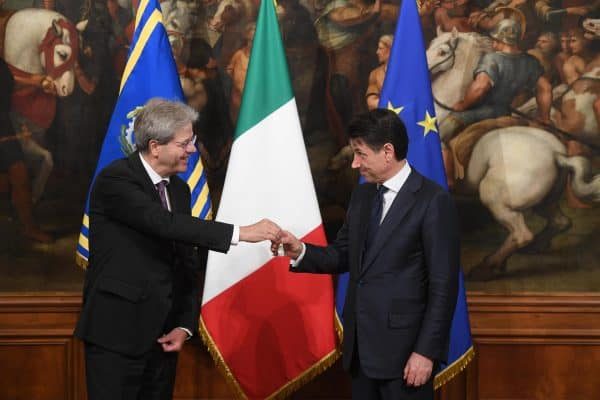 Newly appointed Italian Prime Minister Giuseppe Conte (right) receives from the outgoing Prime Minister Paolo Gentiloni (left) the small silver bell to open the First Council of Minister at Chigi Palace in Rome, 1 Jun 2018. ANSA/CLAUDIO PERI