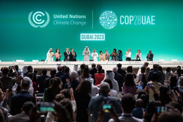 13 December 2023, United Arab Emirates, Dubai: Sultan Ahmed Al-Jaber, President of COP28, (M) and other participants at the conference applaud. On Wednesday morning, the COP presidency presented a revised draft of the final text. Although it has been tightened up, it does not contain a clear end to fossil fuels. Photo: Hannes P. Albert/dpa