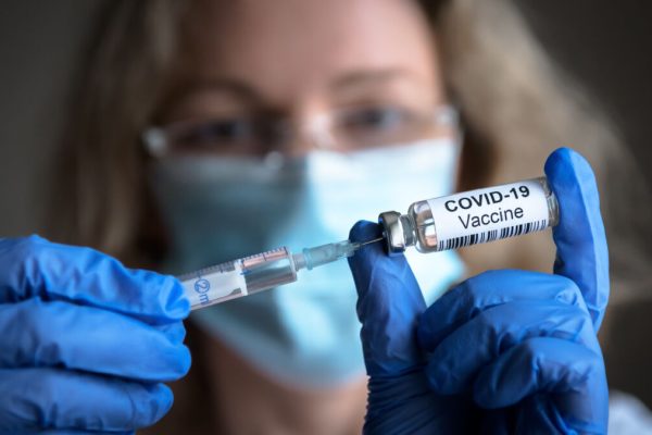 Covid-19,Vaccine,In,Researcher,Hands,,Female,Doctor,Holds,Syringe,And