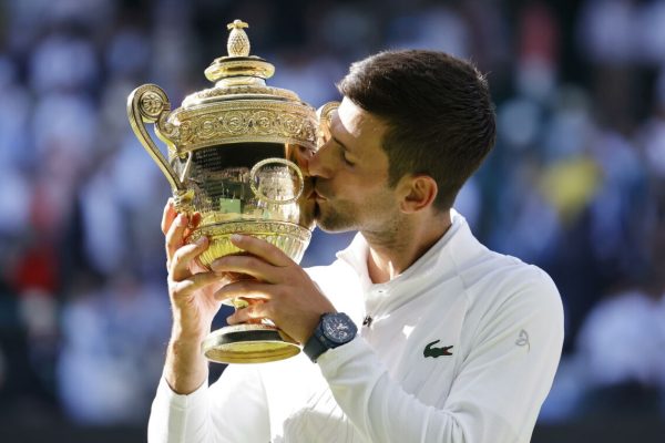 epa10064048 Novak Djokovic of Serbia kisses the trophy after winning the men's final match against Nick Kyrgios of Australia at the Wimbledon Championships, in Wimbledon, Britain, 10 July 2022.  EPA/TOLGA AKMEN   EDITORIAL USE ONLY