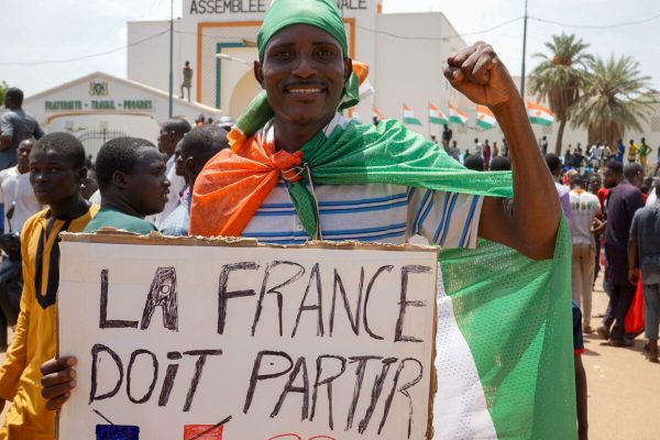 epa10777352 A protester carries a sign that reads France must go during a protest in Niamey, Niger, 30 July 2023. Thousands of supporters of General Abdourahamane Tchiani, head of the Presidential Guard, who declared himself the new leader of Niger after a coup against democratically elected President Mohamed Bazoum on 26 July, took to the streets of Niamey to demonstrate support for the coup.  EPA/ISSIFOU DJIBO