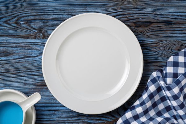 white dish on blue wood table,mediterranean living background