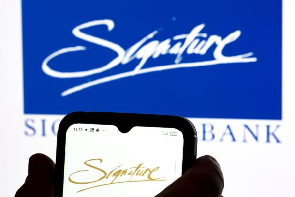 December 28, 2021, Ukraine: In this photo illustration Signature Bank logo seen displayed on a smartphone and in the background. (Credit Image: © Igor Golovniov/SOPA Images via ZUMA Press Wire)