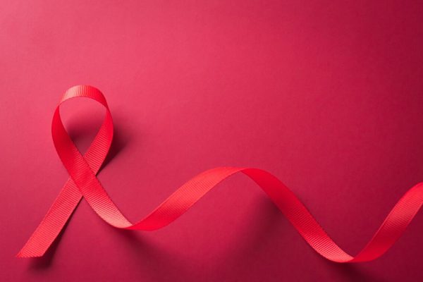 Closeup,Red,Ribbon,Hiv,,World,Aids,Day,Awareness,Ribbon,On