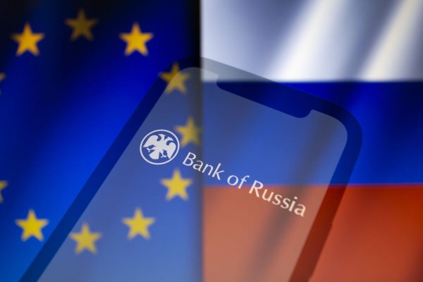February 28, 2022, Asuncion, Paraguay: Illustration: In-camera multiple exposure image shows logo of the Central Bank of the Russian Federation, a.k.a. the Bank of Russia, on smartphone backdropped by displayed cropped waving flags of the European Union and Russia. (Credit Image: © Andre M. Chang/ZUMA Press Wire)