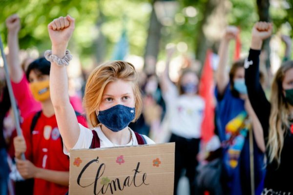 epa09299211 Young people take part in a school strike for the climate in The Hague, the Netherlands, 24 June 2021. By means of a march through The Hague, they want to draw attention to climate change and reducing greenhouse gas emissions.  EPA/BART MAAT