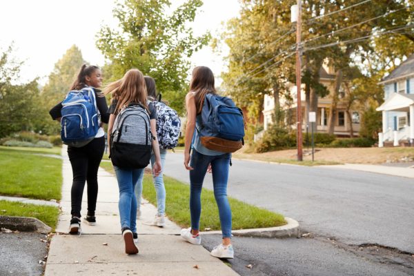 Four,Young,Teen,Girls,Walking,To,School,Together,,Back,View