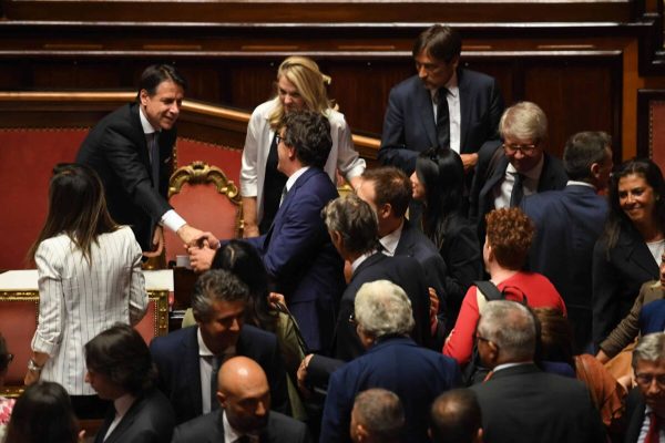 Italian premier Giuseppe Conte is surrounded by members of the cabinet and senators in the Senate at the end of the confidence vote who marks the start of his second government, Rome, Italy, 10 september 2019. The votes in favour of the new government were 168, the votes against 133 and 5 senators didn't vote. ANSA/MAURIZIO BRAMBATTI