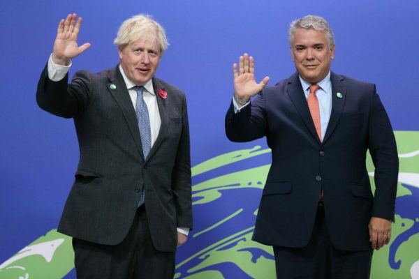 epa09557170 British Prime Minister Boris Johnson (L) greets Colombian President Ivan Duque Marquez (R) as they arrive to attend the COP26 UN Climate Change Conference in Glasgow, Britain 01 November 2021. The 2021 United Nations Climate Change Conference (COP26) runs from 31 October to 12 November 2021 in Glasgow.  EPA/ROBERT PERRY