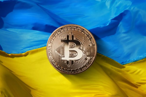 Bitcoin,Gold,On,A,Ukrainian,Flag,Background.,Ukraine,,Successfully,Developing