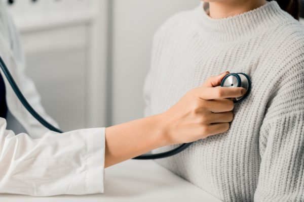 Close,Up,Of,Female,Doctor,Using,Stethoscope,Putting,Beat,Heart