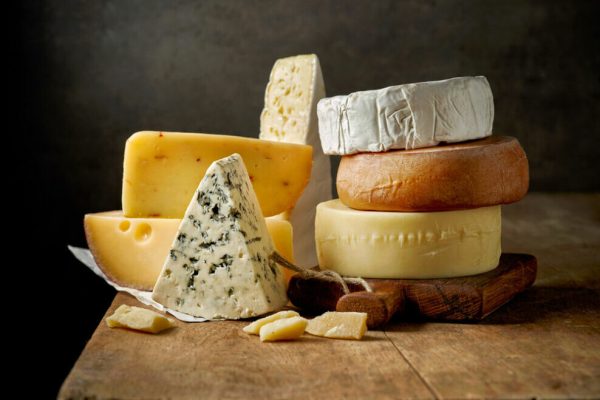 Various,Types,Of,Cheese,On,Rustic,Wooden,Table