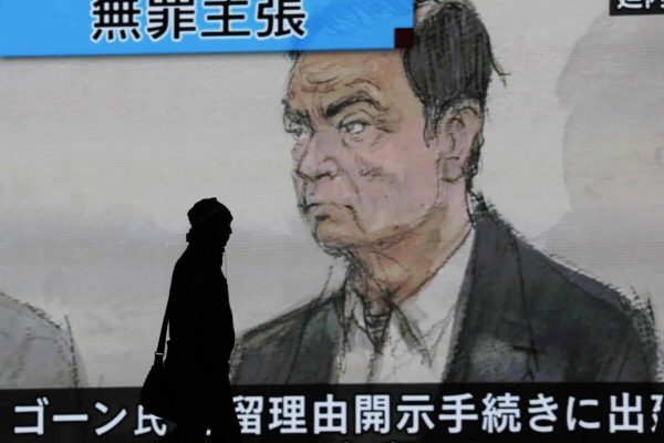 epa07269002 Pedestrians walk past a large-scale screen displaying a news program showing a courtroom drawing of former Nissan Motor Co Ltd chairman Carlos Ghosn attending a court hearing at Tokyo district court, in Tokyo, Japan, 08 January 2019. Earlier in the day, Carlos Ghosn had his first hearing at the Tokyo District Court, his first public appearance since his arrest on 19 November 2018. According to reports, Ghosn stated that he was 'wrongly accused and unfairly detained'.  EPA/KIMIMASA MAYAMA