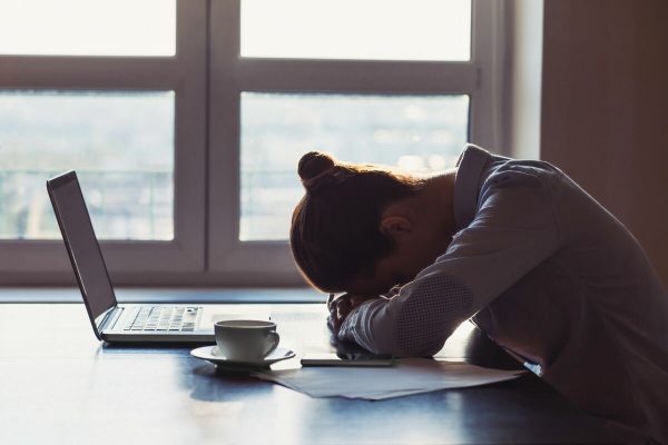 Tired,Businesswoman,Sleeping,On,Table,In,Office.,Young,Exhausted,Girl