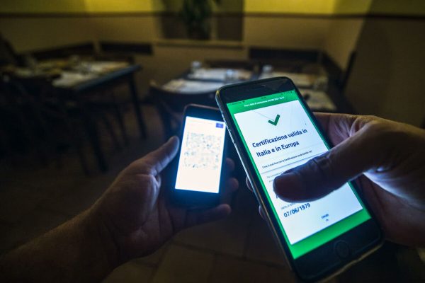 A visitor's Covid-19 Green Pass is checked at the entrance to a restaurant in Rome, Italy, 09 August 2021. Effective from 06 August, the so-called Green Pass is advocated by the government as the alternative to lockdowns in the light of the spreading Delta variant of the Sars-Cov-2 pandemic coronavirus. People who do not hold the certificate that identifies them as either immunised, recovered or tested for Covid-19 may be excluded from indoor venues and for access to amusement parks it is necessary to be up to date with anti-covid-19 vaccinations, or have a negative swab in the last 48 hours. ANSA/ANGELO CARCONI