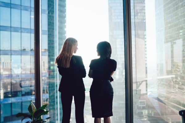 Back,View,Of,Female,Colleagues,In,Formal,Wear,Standing,Near