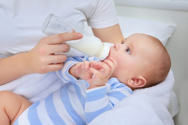 Mother,Holding,And,Feeding,Baby,From,Bottle