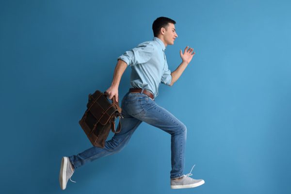 Running,Man,With,Briefcase,On,Color,Background