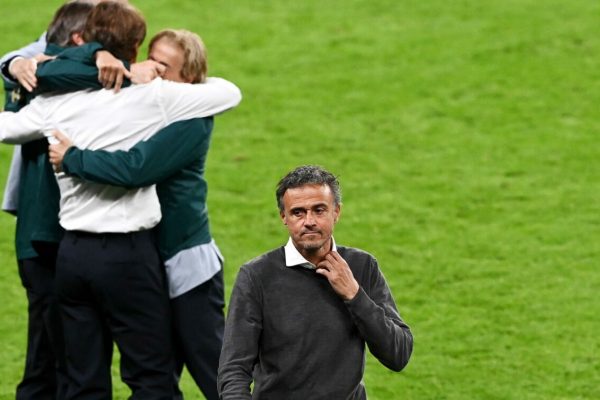 epa09327300 Head coach Luis Enrique of Spain walks off as his Italian counterpart Roberto Mancini (white shirt) celebrates with coaching staff after the team won the UEFA EURO 2020 semi final between Italy and Spain in London, Britain, 06 July 2021.  EPA/Facundo Arrizabalaga / POOL (RESTRICTIONS: For editorial news reporting purposes only. Images must appear as still images and must not emulate match action video footage. Photographs published in online publications shall have an interval of at least 20 seconds between the posting.)
