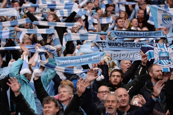 epa04201500 Manchester City fans celebrate after winning their game of the English Premier League soccer against West Ham United at the Etihad Stadium in Manchester, Britain, 11 May 2014.  ManCity won the Premier League.  EPA/ANDY RAIN Special Instructions DataCo terms and conditions apply http://www.epa.eu/downloads/DataCo-TCs.pdf