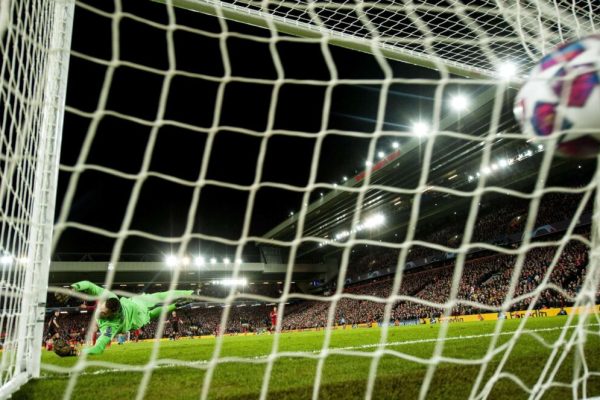 epa08287566 Marcos Llorente (L) of Atletico beats Liverpool goalkeeper Adrian to sore his second goal during the UEFA Champions League Round of 16, second leg match between Liverpool FC and Atletico Madrid in Liverpool, Britain, 11 March 2020.  EPA/PETER POWELL