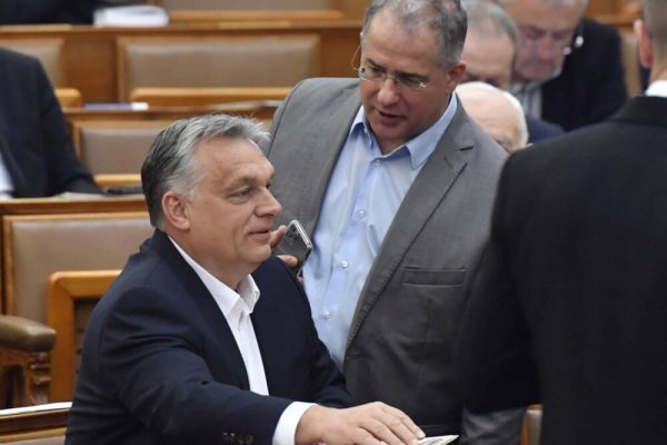 epa08332119 Hungarian Prime Minister Viktor Orban (L) chats with MP of the governing Fidesz party Lajos Kosa during the plenary session of the Parliament in Budapest, Hungary, 30 March 2020. Reports state MPs approved legislation that extends a state of emergency and gives the government extraordinary powers due to the ongoing pandemic of the Covid-19 disease caused by the SARS-CoV-2 coronavirus.  EPA/Zoltan Mathe HUNGARY OUT