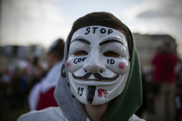 October 24, 2020, Warsaw, Poland: A protester wearing an Anonymous mask takes part during the demonstration..Opponents of restrictions imposed by the government in connection with the spread of the coronavirus protested in Warsaw. Participants of the demonstration did not wear face coverings and did not keep social distance. Because of tightened restrictions due to covid 19 spread from 24th October, it is illegal to gather and demonstrate. Protesters didn't want to diverge and the demonstration turned into riots, police used tear gas and detained numerous protesters. (Credit Image: © Attila Husejnow/SOPA Images via ZUMA Wire)