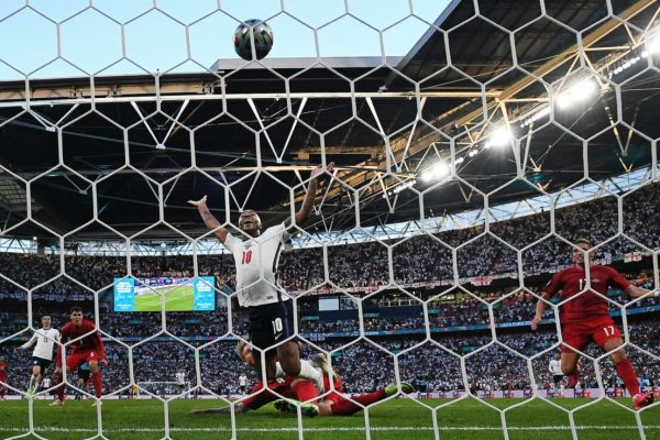 epa09330601 England's Raheem Sterling (C) watches the ball fall into the Denmark goal after Simon Kjaer put the ball into his own net to tie the score 1-1 at Wembley Stadium in in London, Britain, 07 June 2021. England won 2-1 after extra time and will meet Italy in Sunday's final.  EPA/ANDY RAIN