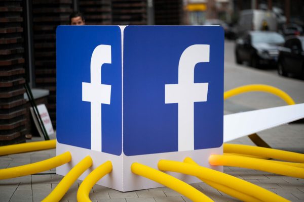 14 May 2021, Hamburg: The Facebook logo stands w·during a demonstration by activists of the campaign network Campact in front of the headquarters of the internet company Facebook under the slogan ·Po_Stop the WhatsApp data theft' against new terms of use of the communication app ·Po_WhatsApp'. Photo: Daniel Reinhardt/dpa