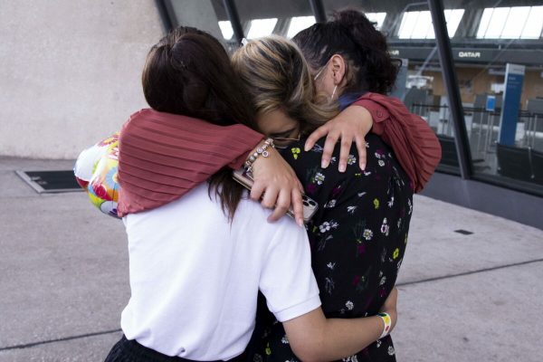 epa09436933 Marcy Barakzai (C) of Alexandria, Virginia, hugs her nieces Marian Barakzai (L ,14 years old) and Mariam Barakzai (R, 17 years old) - both evacuated from Kabul, Afghanistan;  after her nieces arrived at Washington Dulles International Airport in Chantilly, Virginia, USA, 30 August 2021. An agreement was reached with the Taliban to allow the coninued evacuation of Afghan allies out of the country after the 31 August withdrawal deadline.  EPA/MICHAEL REYNOLDS Permission granted to photograph these minors
