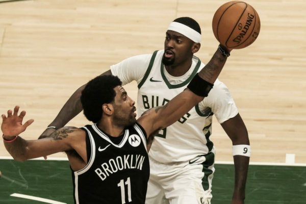 epa09268835 Brooklyn Nets guard Kyrie Irving of Australia (L) grabs a rebound in front of Milwaukee Bucks center Bobby Portis (R) during the NBA Eastern Conference semi-final playoff game between the Brooklyn Nets and the Milwaukee Bucks at Fiserv Forum in Milwaukee, Wisconsin, USA, 13 June 2021.  EPA/TANNEN MAURY  SHUTTERSTOCK OUT
