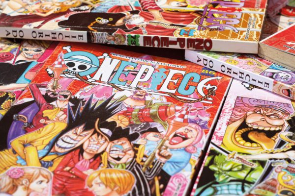 Banjar, Indonesia - August 21, 2022:  Japanese Manga One piece - comic book published in Weekly Shonen Jump Magazine. Isolated in Red Background.