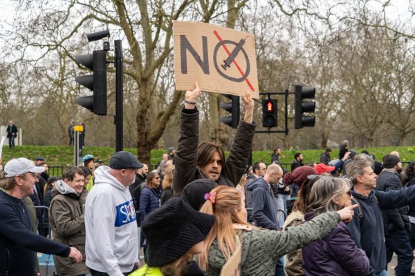 Man,Holds,A,Sign,During,An,Anti,Lockdown,Protest,In