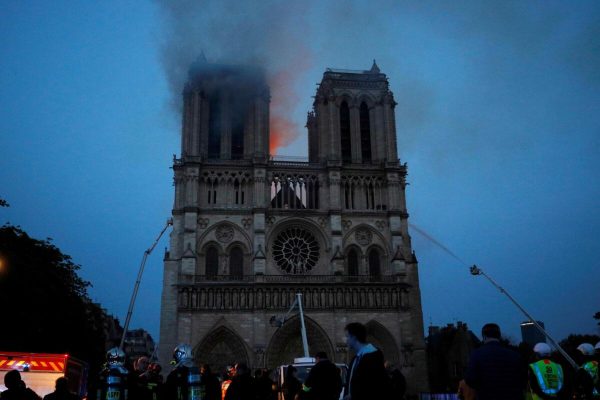 epa07508845 Paris Fire brigade members spray water onto the facade of the Notre Dame Cathedral during the visit by French President Emmanuel Macron (not pictured) in Paris, France, 15 April 2019. A fire started in the late afternoon in one of the most visited monuments of the French capital.  EPA/PHILIPPE WOJAZER / POOL  MAXPPP OUT