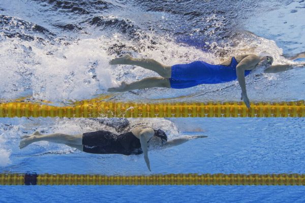 epa09367619 (From Top) Viktoria Mihalyvari-Farkas of Hungary and Julia Hassler of Liechtenstein compete in the women's 1500m Freestyle Heats during the Swimming events of the Tokyo 2020 Olympic Games at the Tokyo Aquatics Centre in Tokyo, Japan, 26 July 2021.  EPA/Patrick B. Kraemer